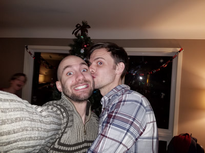 Todd gives Dirk a kiss on the cheek at their holiday party