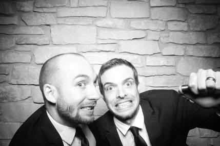 Dirk and Todd making silly faces in a black and white wedding photo